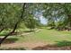 Scenic view of the community park with walking paths, lush green lawns, and mature shade trees at 5029 S Carlyle Dr, Gilbert, AZ 85298