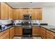 Well-equipped kitchen featuring a gas range, stainless steel appliances, and dark countertops at 5029 S Carlyle Dr, Gilbert, AZ 85298