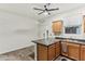 Kitchen has wood cabinets, breakfast bar, modern appliances, and is adjacent to a bright white dining space at 5029 S Carlyle Dr, Gilbert, AZ 85298