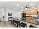 Bright kitchen with seating at a dark countertop island and stainless appliances at 5029 S Carlyle Dr, Gilbert, AZ 85298