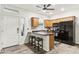 Bright kitchen features modern appliances, wood cabinets, breakfast bar with seating, and stylish tile flooring at 5029 S Carlyle Dr, Gilbert, AZ 85298