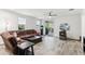 Spacious living room with a comfortable leather couch, ceiling fan, and sliding door to backyard at 5029 S Carlyle Dr, Gilbert, AZ 85298