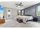 Tranquil main bedroom features a ceiling fan, access to outside, and large windows at 5029 S Carlyle Dr, Gilbert, AZ 85298