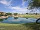 Community pond surrounded by green grass, trees, and walking paths offering a serene outdoor space at 5029 S Carlyle Dr, Gilbert, AZ 85298