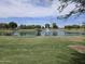 Scenic view of a well-maintained community pond featuring a fountain and landscaped surroundings at 5029 S Carlyle Dr, Gilbert, AZ 85298
