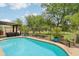 Sparkling pool featuring golf course views, privacy fence, and mature landscaping at 5029 S Carlyle Dr, Gilbert, AZ 85298