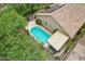 Aerial view of a backyard pool, hot tub, and patio area with an awning cover on a sunny day at 5029 S Carlyle Dr, Gilbert, AZ 85298