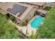Aerial view of a home featuring a sparkling pool with a patio, solar panels, and a covered outdoor dining area at 5029 S Carlyle Dr, Gilbert, AZ 85298
