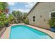 Private backyard pool surrounded by meticulous landscaping and charming architectural details at 5029 S Carlyle Dr, Gilbert, AZ 85298