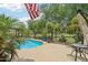 Beautiful pool, patio with umbrella-shaded table, and tropical landscaping at 5029 S Carlyle Dr, Gilbert, AZ 85298