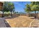 Large backyard with desert landscaping, mature trees, and block wall fencing at 508 W San Angelo St, Gilbert, AZ 85233
