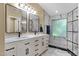 Remodeled bathroom with dual sinks, walk-in shower and updated lighting at 508 W San Angelo St, Gilbert, AZ 85233
