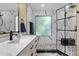 Modern bathroom with marble tiling, glass shower, and dark fixtures for a sleek design at 508 W San Angelo St, Gilbert, AZ 85233
