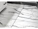 Elegant bathroom floor features white marble tiles with striking black veining at 508 W San Angelo St, Gilbert, AZ 85233