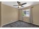 Cozy bedroom with neutral walls and soft gray carpeting, featuring a ceiling fan at 508 W San Angelo St, Gilbert, AZ 85233