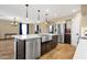 Bright kitchen with white cabinets, stainless steel appliances, kitchen island with a sink and bar seating at 508 W San Angelo St, Gilbert, AZ 85233