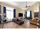 Spacious living room featuring tile floors, comfortable seating, and abundant natural light from large windows at 508 W San Angelo St, Gilbert, AZ 85233