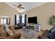 Spacious living room with high ceilings, tile floors, and modern entertainment center at 508 W San Angelo St, Gilbert, AZ 85233