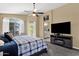 Main bedroom suite with ceiling fan, updated lighting and TV at 508 W San Angelo St, Gilbert, AZ 85233