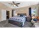 Main bedroom with neutral carpet, ceiling fan, updated lighting and walk-in closet at 508 W San Angelo St, Gilbert, AZ 85233