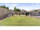 Spacious backyard featuring lush green lawn, block wall, and refreshing private pool at 512 W Encinas St, Gilbert, AZ 85233
