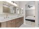 Elegant bathroom with double vanity, stylish mirrors, and a walk-in shower at 512 W Encinas St, Gilbert, AZ 85233