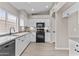 Updated kitchen with sleek countertops, white cabinets, and stainless steel appliances at 512 W Encinas St, Gilbert, AZ 85233