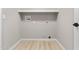 The laundry room has connections for a washer and dryer, and light-colored walls and hardwood floors at 512 W Encinas St, Gilbert, AZ 85233