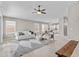 Spacious living room with a ceiling fan and seamless access to the dining area and updated kitchen at 512 W Encinas St, Gilbert, AZ 85233