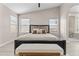 Spacious main bedroom with a bed, a bench, and windows for ample natural light at 512 W Encinas St, Gilbert, AZ 85233