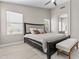 Well-lit main bedroom featuring a large bed, seating, and an ensuite bathroom at 512 W Encinas St, Gilbert, AZ 85233