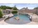 A beautiful pool with rock features and waterfall provides a relaxing backyard oasis at 512 W Encinas St, Gilbert, AZ 85233