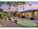 Expansive backyard with a charming putting green, covered patio and meticulously manicured landscaping at 5291 S Bradshaw Pl, Chandler, AZ 85249