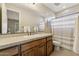 Well-maintained bathroom featuring a tiled countertop, wood cabinets, and a shower/tub combination with neutral tones at 5291 S Bradshaw Pl, Chandler, AZ 85249