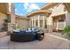 Cozy outdoor living space with a stone fireplace, comfortable seating, and serene ambiance in private courtyard at 5291 S Bradshaw Pl, Chandler, AZ 85249