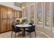 This dining nook boasts a modern chandelier, four windows with light shutters and a marble table at 5291 S Bradshaw Pl, Chandler, AZ 85249