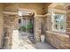 Covered front entryway featuring stone accents, a gated entry, and decorative planters, creating a welcoming ambiance at 5291 S Bradshaw Pl, Chandler, AZ 85249