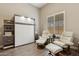Comfortable guest room with a murphy bed, shelving, and two leather recliners, providing a relaxing retreat at 5291 S Bradshaw Pl, Chandler, AZ 85249