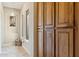 Hallway with natural light, view to a small court yard, and large wood cabinets that offers ample storage at 5291 S Bradshaw Pl, Chandler, AZ 85249