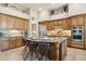 This eat-in kitchen offers a large island with seating, a breakfast bar, and custom cabinetry at 5291 S Bradshaw Pl, Chandler, AZ 85249