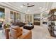 Spacious living room with a fireplace, comfortable leather furniture, and tray ceilings with plenty of natural light at 5291 S Bradshaw Pl, Chandler, AZ 85249
