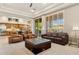 This inviting living room features leather seating, a tray ceiling, and lots of natural light at 5291 S Bradshaw Pl, Chandler, AZ 85249