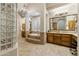 A view of the main bathroom featuring tub, vanity, chandelier, and glass block window at 5291 S Bradshaw Pl, Chandler, AZ 85249