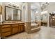 A secondary view of the main bathroom featuring dual vanities, makeup vanity and arched doorway at 5291 S Bradshaw Pl, Chandler, AZ 85249