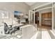 Home office with great lighting with a modern desk, comfortable seating, and seamless access to the hallway at 5291 S Bradshaw Pl, Chandler, AZ 85249