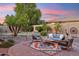Serene patio area featuring comfortable seating around a decorative rug, complemented by lush landscaping at 5291 S Bradshaw Pl, Chandler, AZ 85249