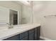 Bathroom vanity with a quartz countertop, single sink, and large mirror at 695 S 221St Dr, Buckeye, AZ 85326