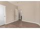This bedroom features neutral walls, an open doorway, and wood-look floors at 695 S 221St Dr, Buckeye, AZ 85326