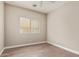 This bedroom features neutral walls, a window with blinds, and wood-look floors at 695 S 221St Dr, Buckeye, AZ 85326