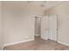 This bedroom features neutral walls, bi-fold closet doors, and wood-look floors at 695 S 221St Dr, Buckeye, AZ 85326